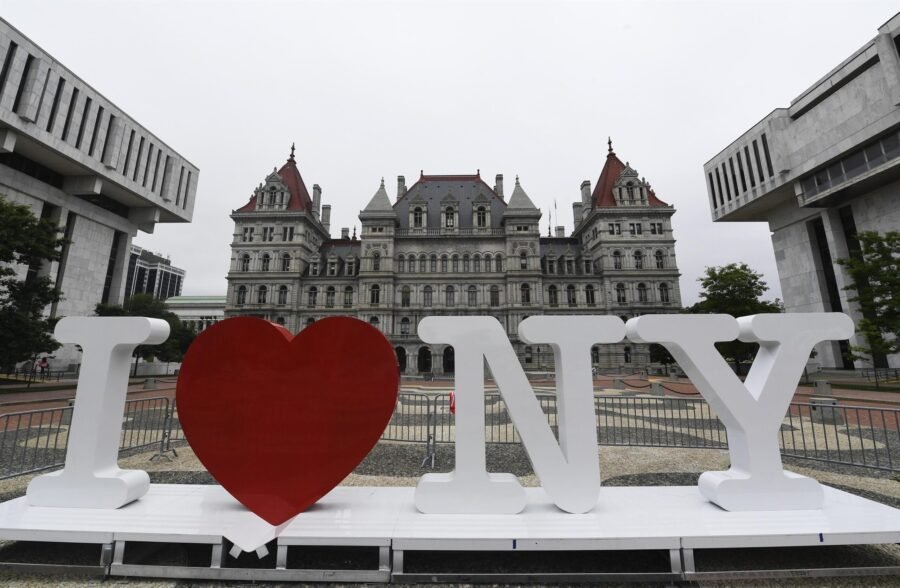 I LOVE NY frente al Capitolio del Estado de Nueva York, en Albany. Creada en 1977, la conocida identidad turística representa al Estado de Nueva York y no exclusivamente a New York City. La instalación de Empire State Plaza permite observar visualmente esa relación entre promoción turística y ámbito estatal.